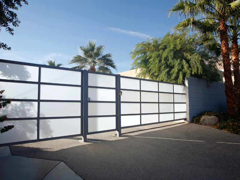 An image showing a secure residential fence protecting a home and yard.