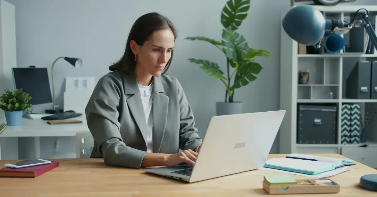 Woman reviewing documents related to Form 1099 late filing penalty at home office.