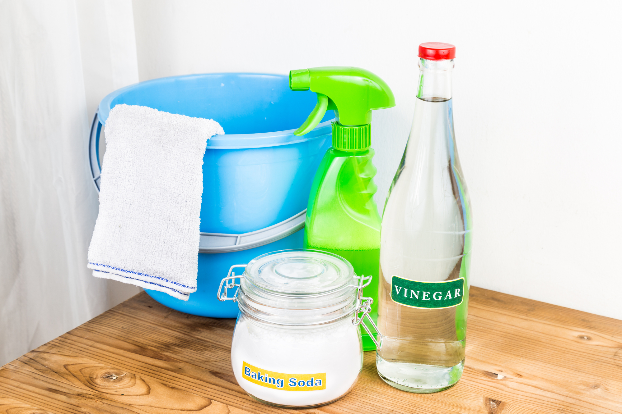 White vinegar in spray bottle and microfiber cloth