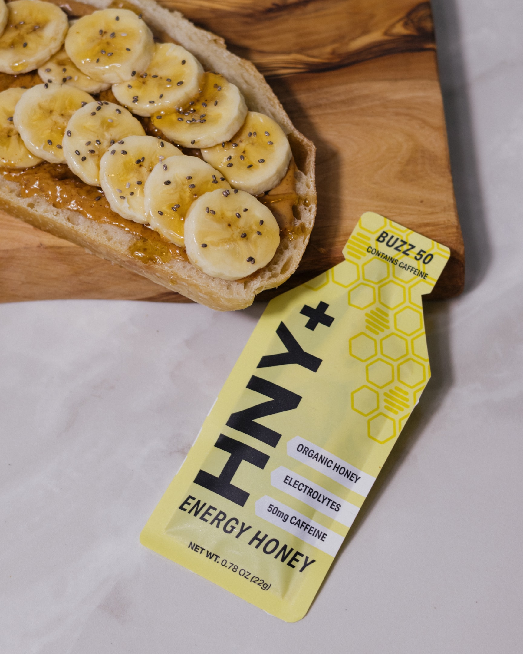 An athlete using an energy gel during a training session, illustrating performance.