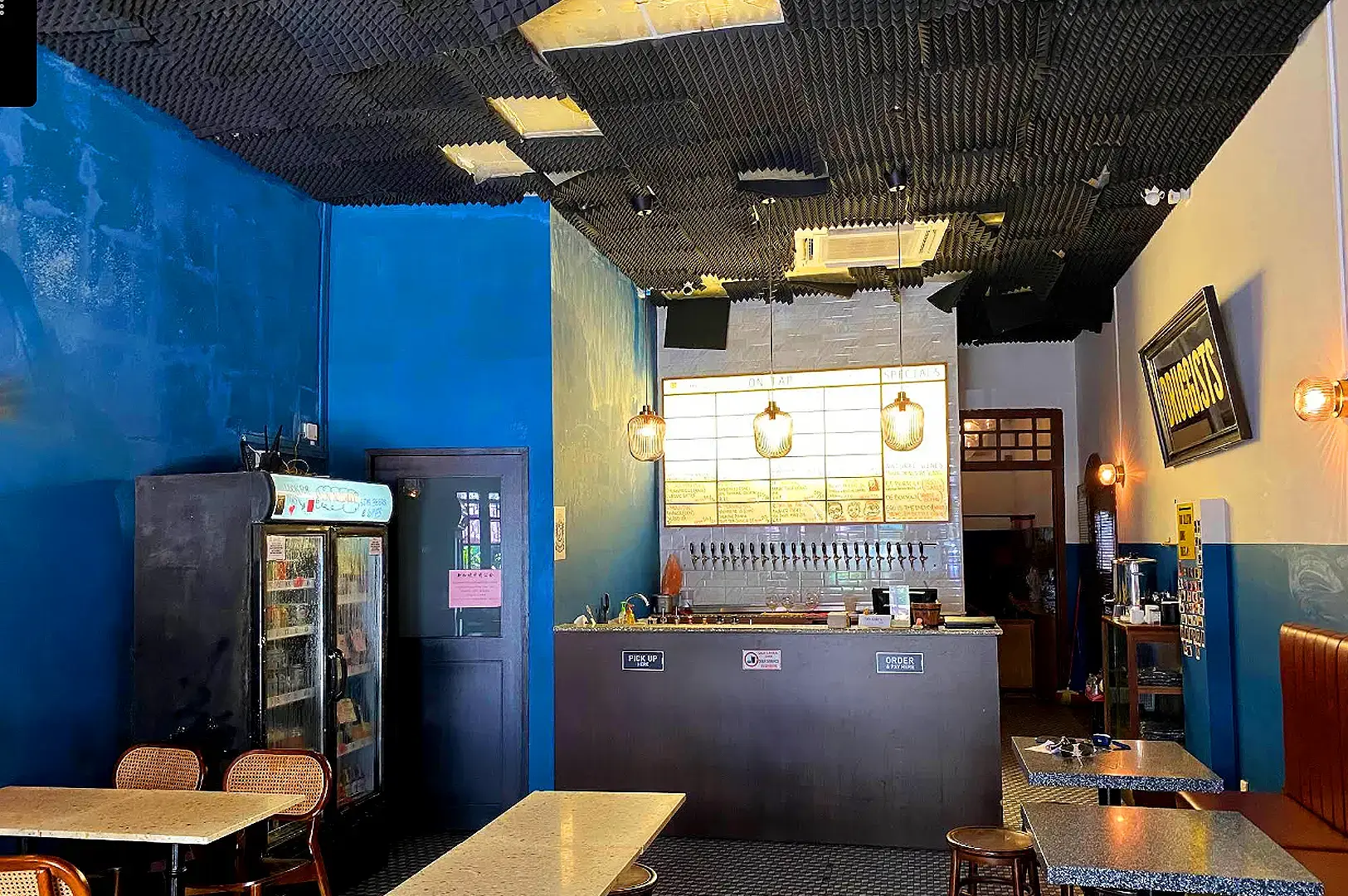 Druggists Singapore craft beer bar interior with blue walls and beer taps