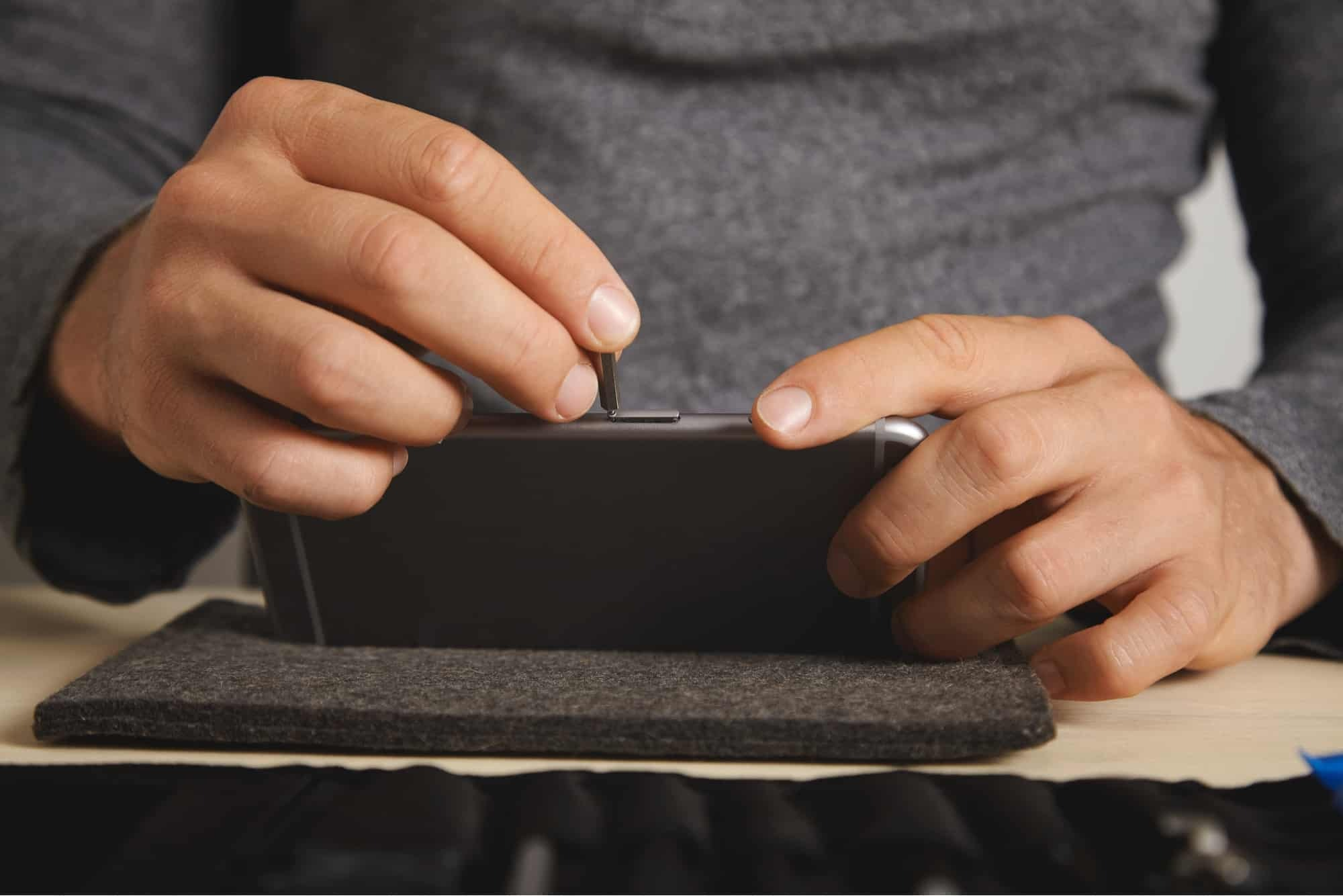 Man changing the SIM card of his phone.