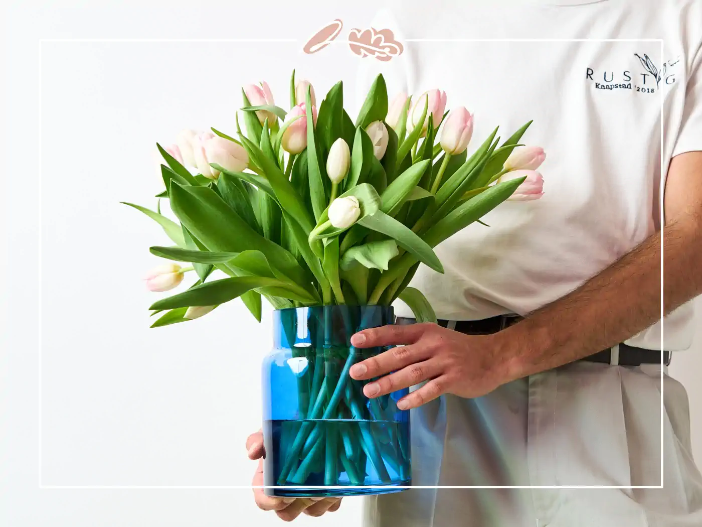 Person holding a vase with pink tulips - Fabulous Flowers and gifts