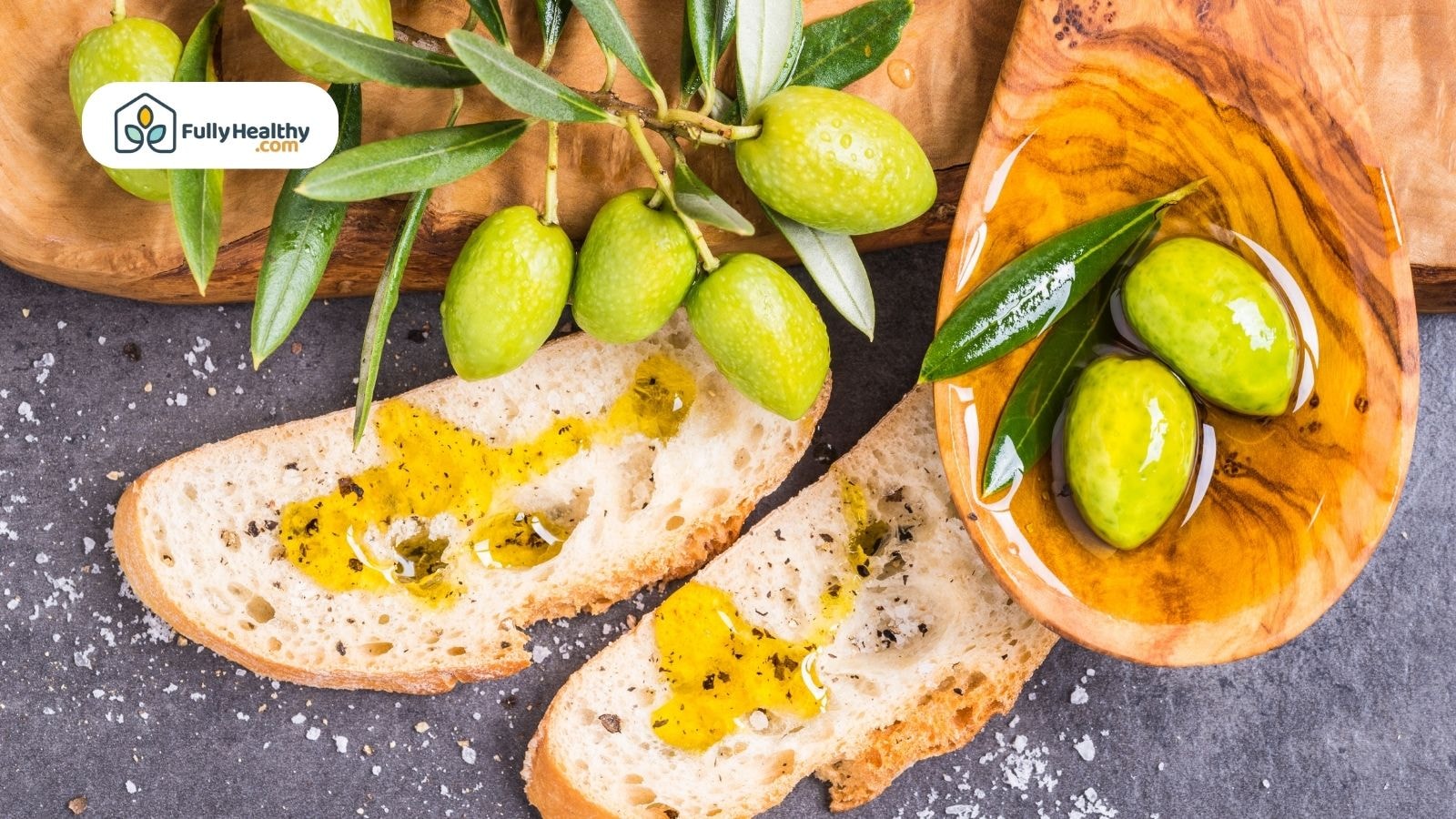 Slices of bread drizzled with golden olive oil and fresh green olives.