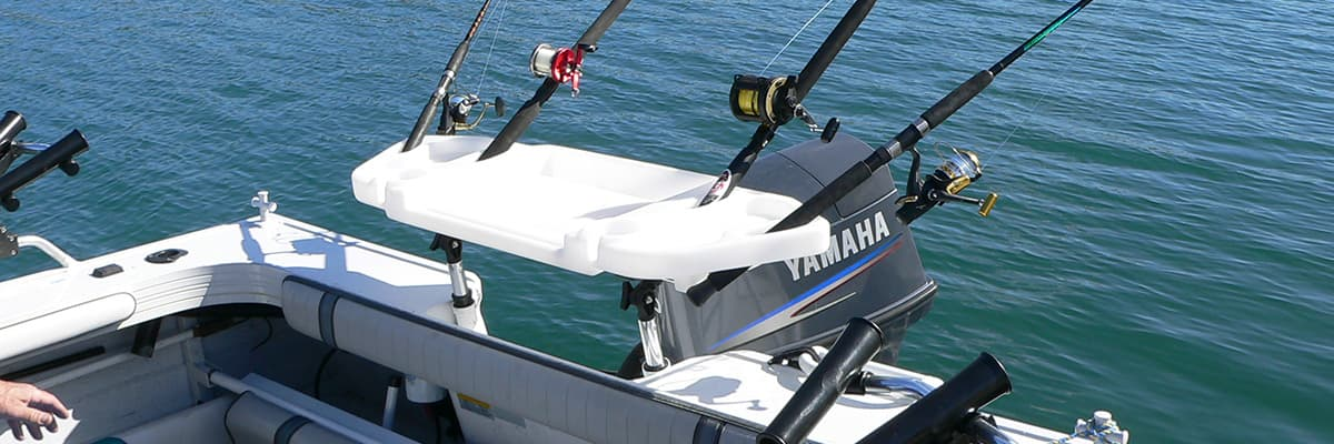 Bait board on boat deck with rod holders