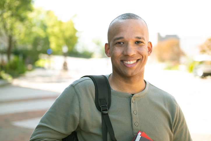 Male veteran carrying a backpack.