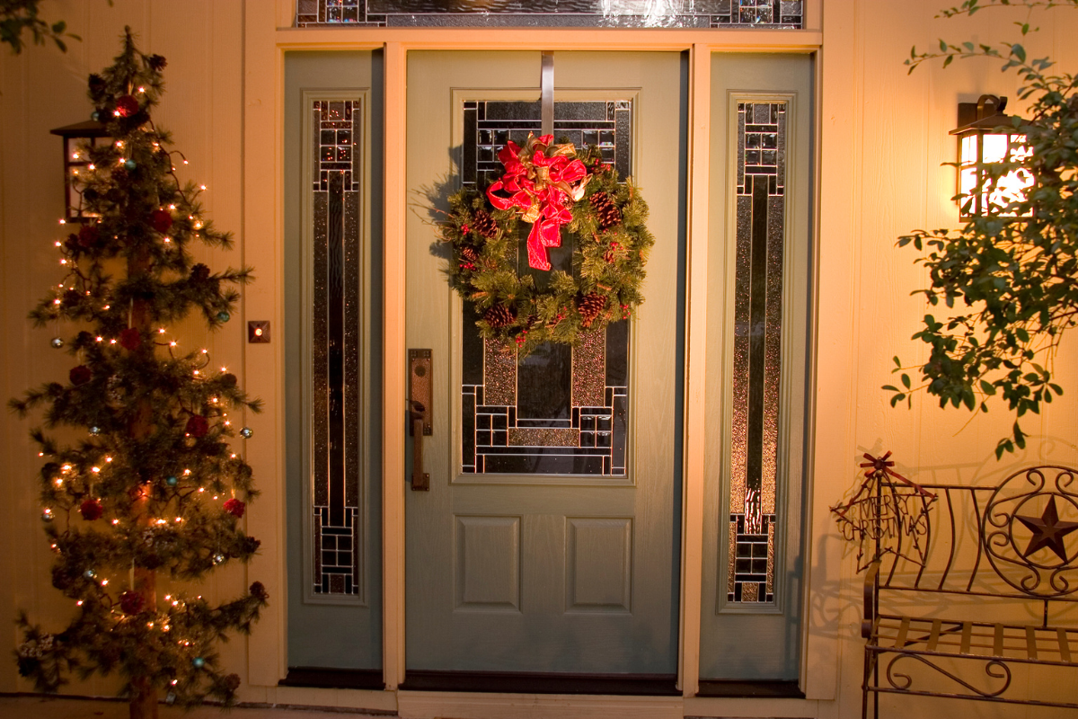 A cozy farmhouse entryway decorated for Christmas with a warm ambiance.