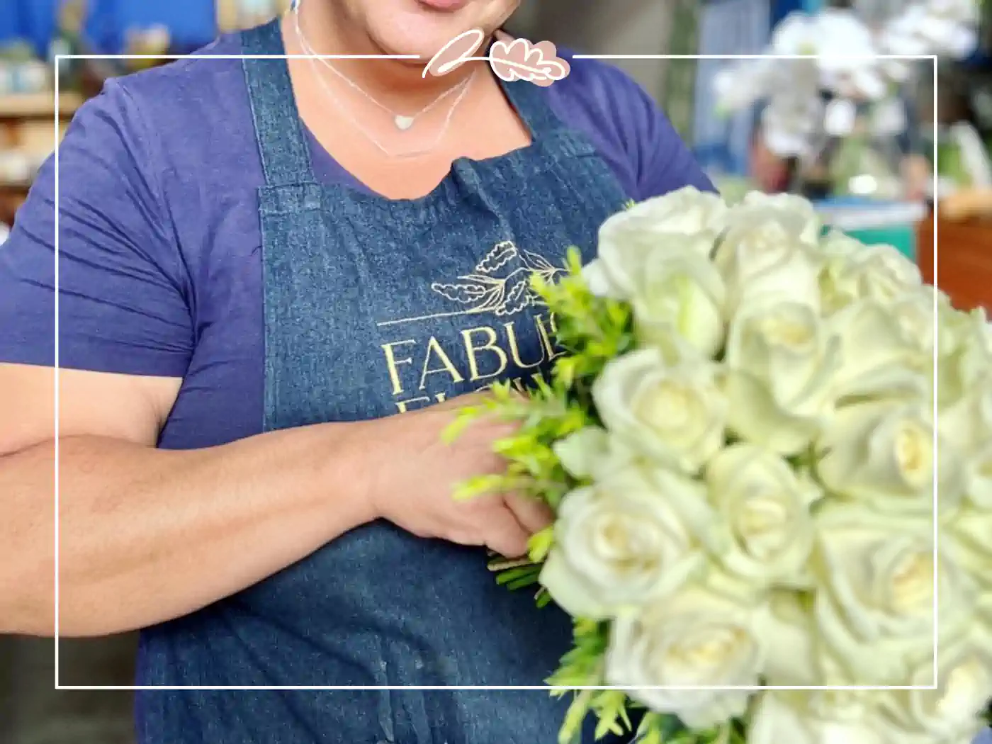 A dedicated florist arranging a bouquet of pristine white roses. Fabulous Flowers and Gifts