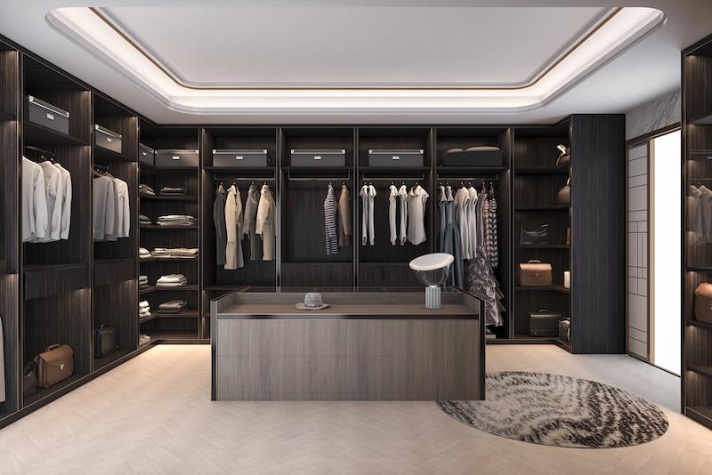 Luxury Walk-In Closet with Built-In Storage Luxury walk-in closet with dark wood shelving, hanging space, and a central storage island