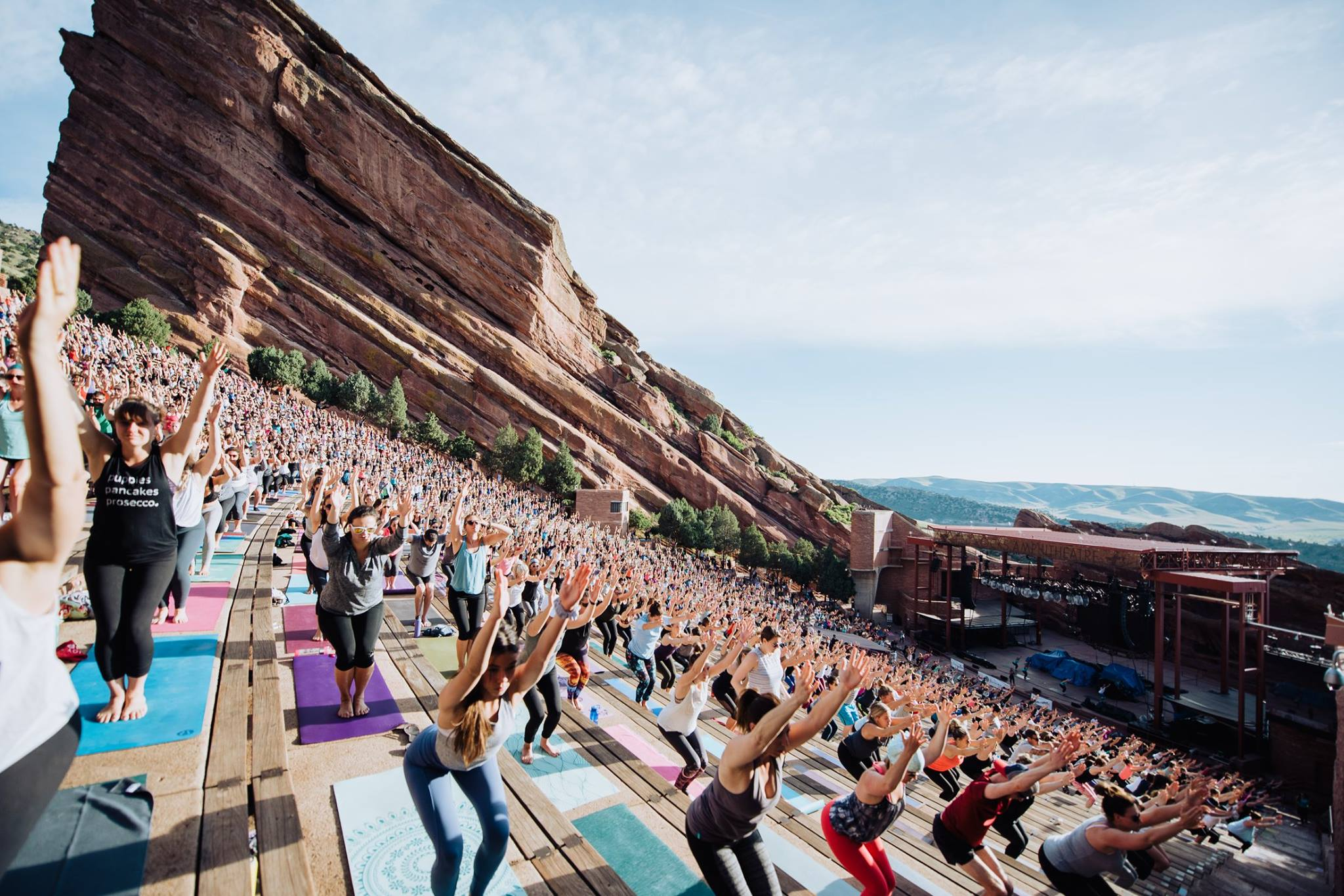 A large group participating in Yoga on the Rocks at Red Rocks Amphitheatre