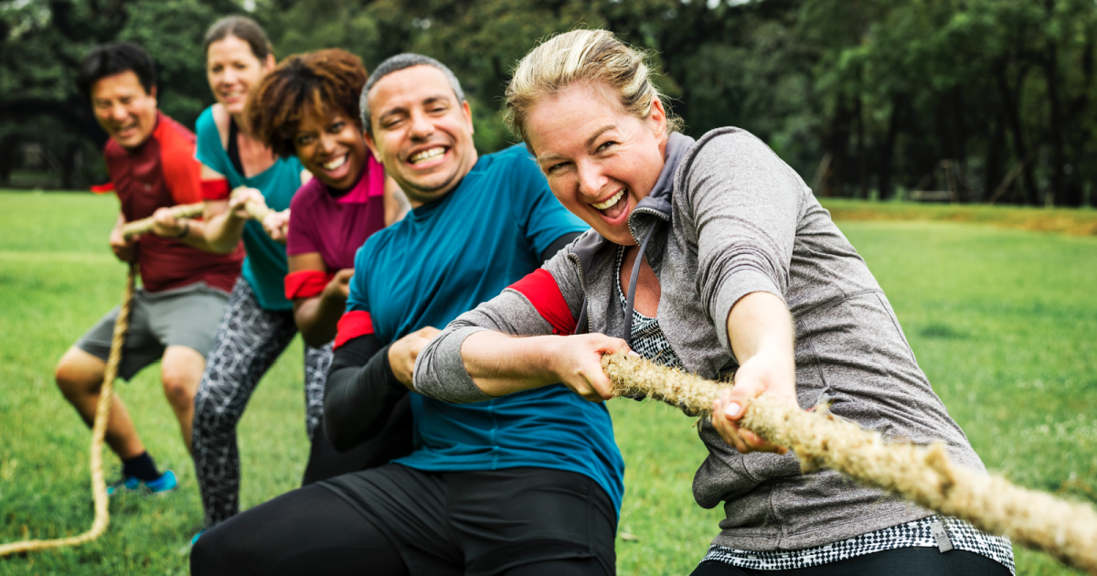 Adults engaged in a tug-of-war, symbolizing the relationship struggles when a partner exhibits ADHD symptoms; guidance offered by Loving at Your Best Marriage and Couples Counseling.