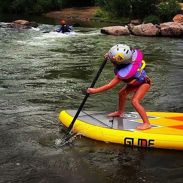 child on stand up paddleboard