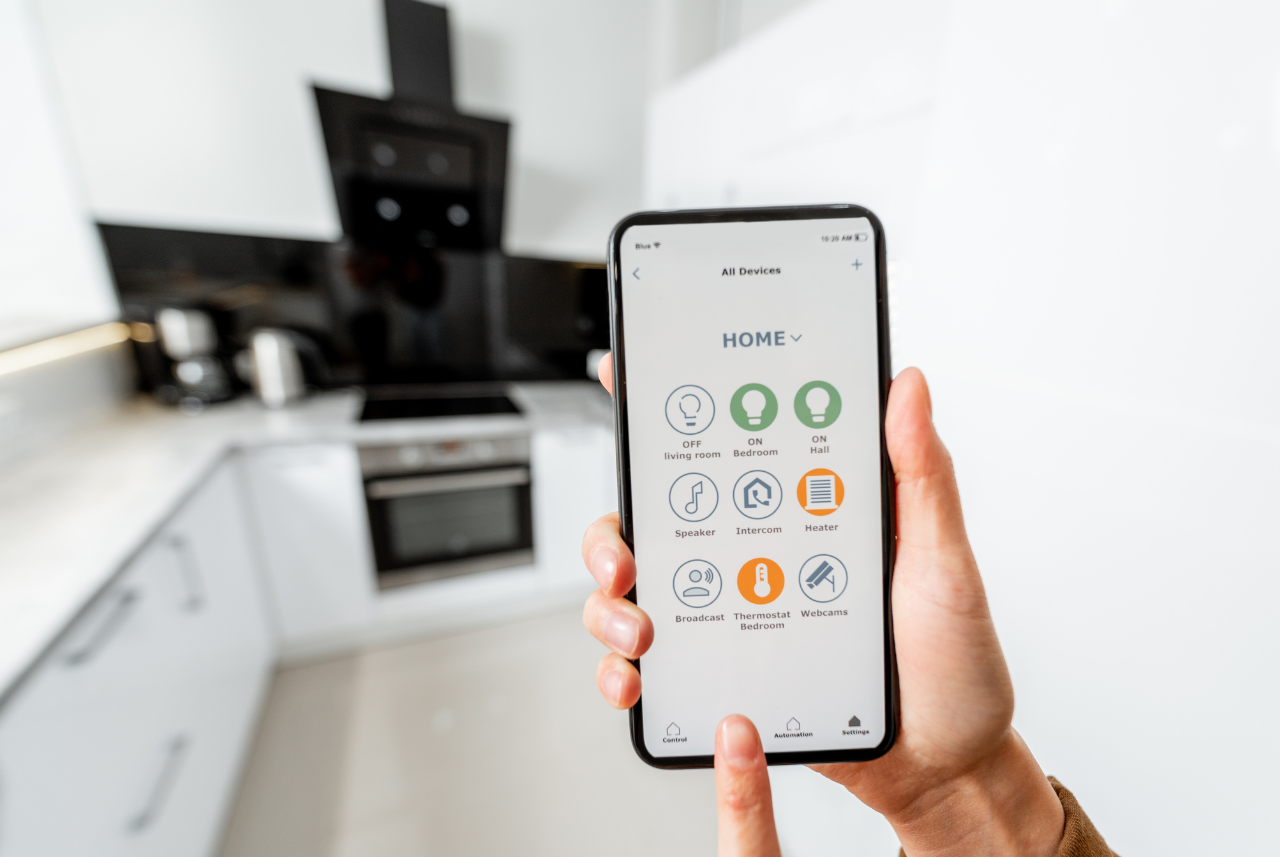 A person using a smart home app in a kitchen