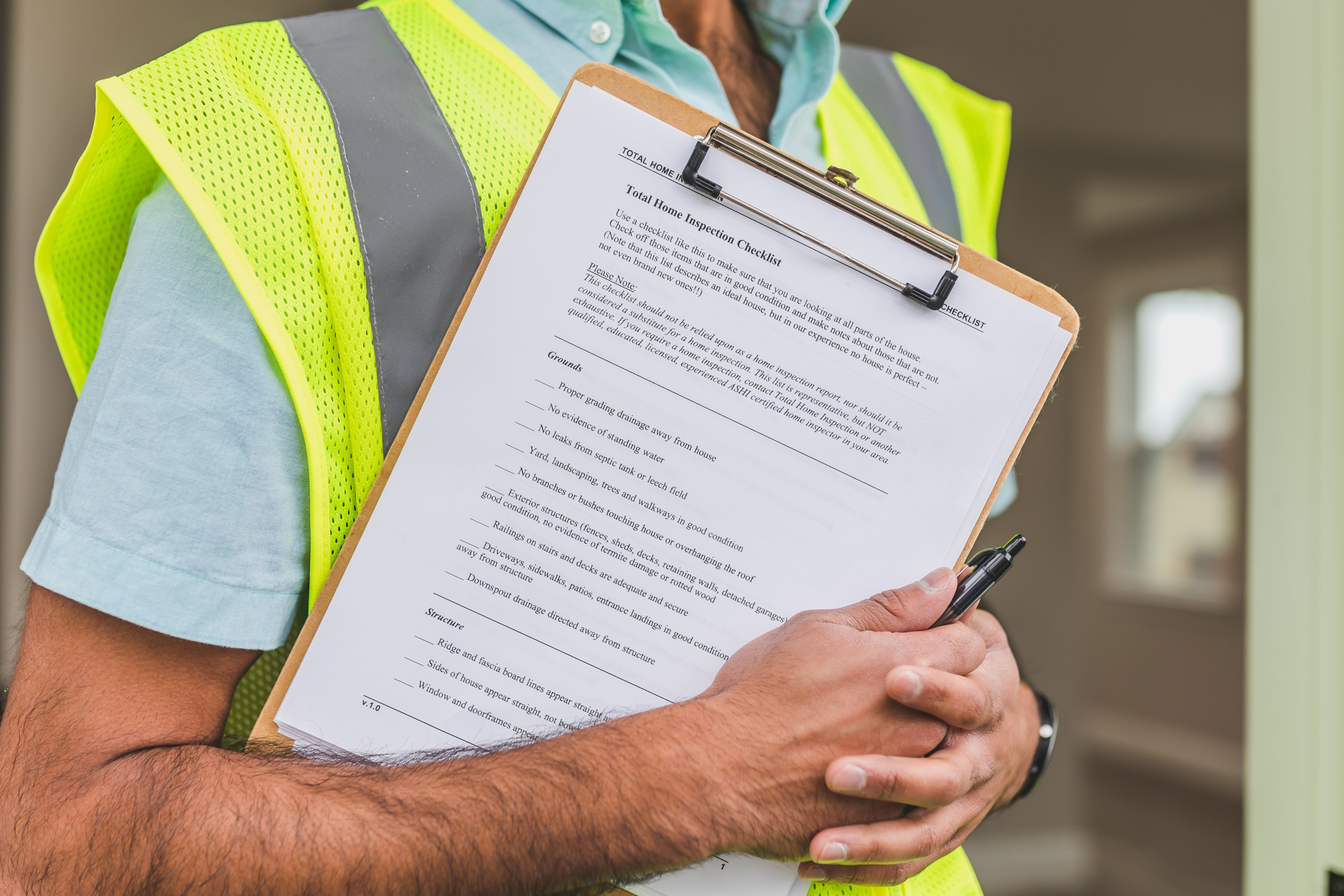 a man holding a property inspection form