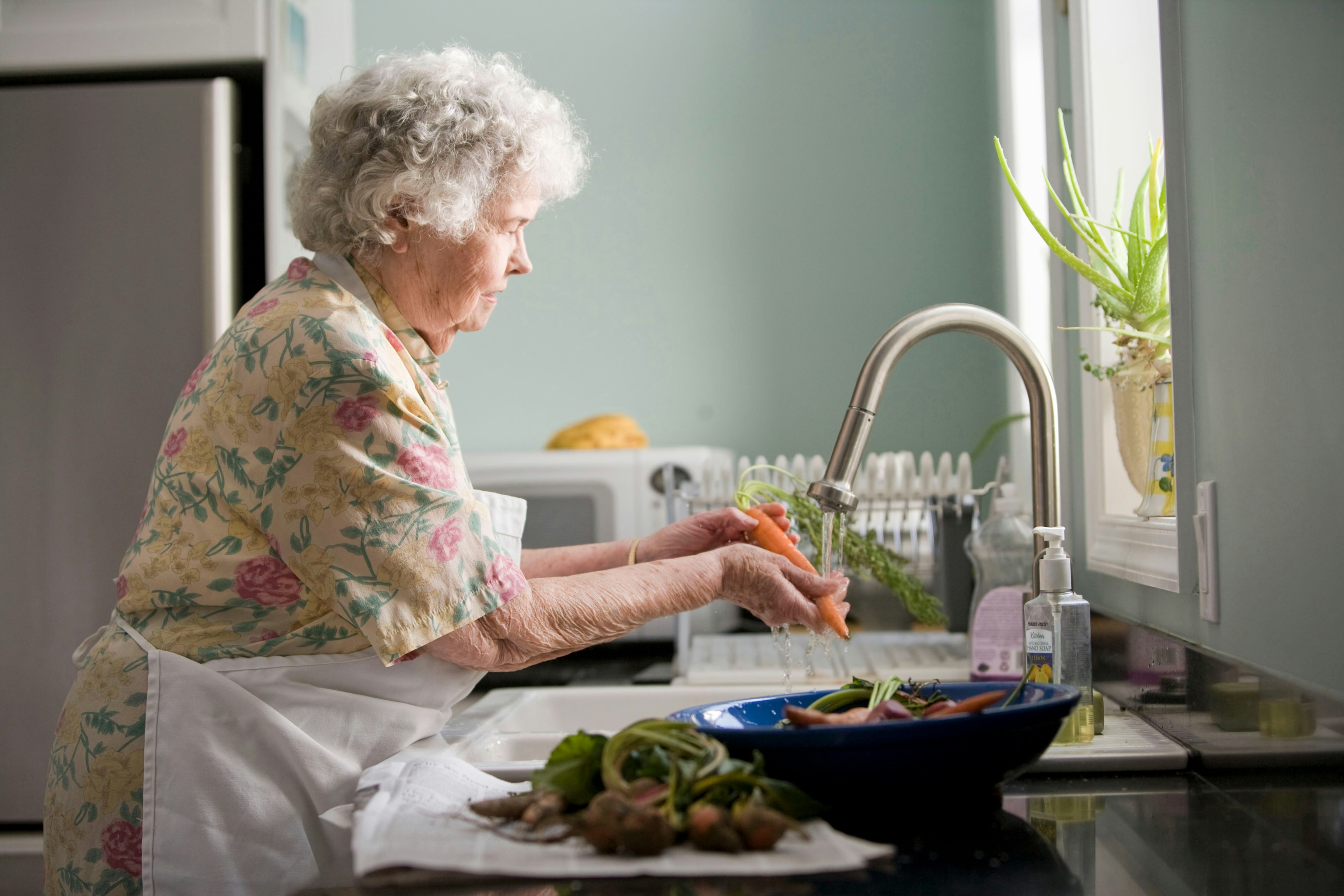 Senior citizen cooking in her home that she is motivated to sell.