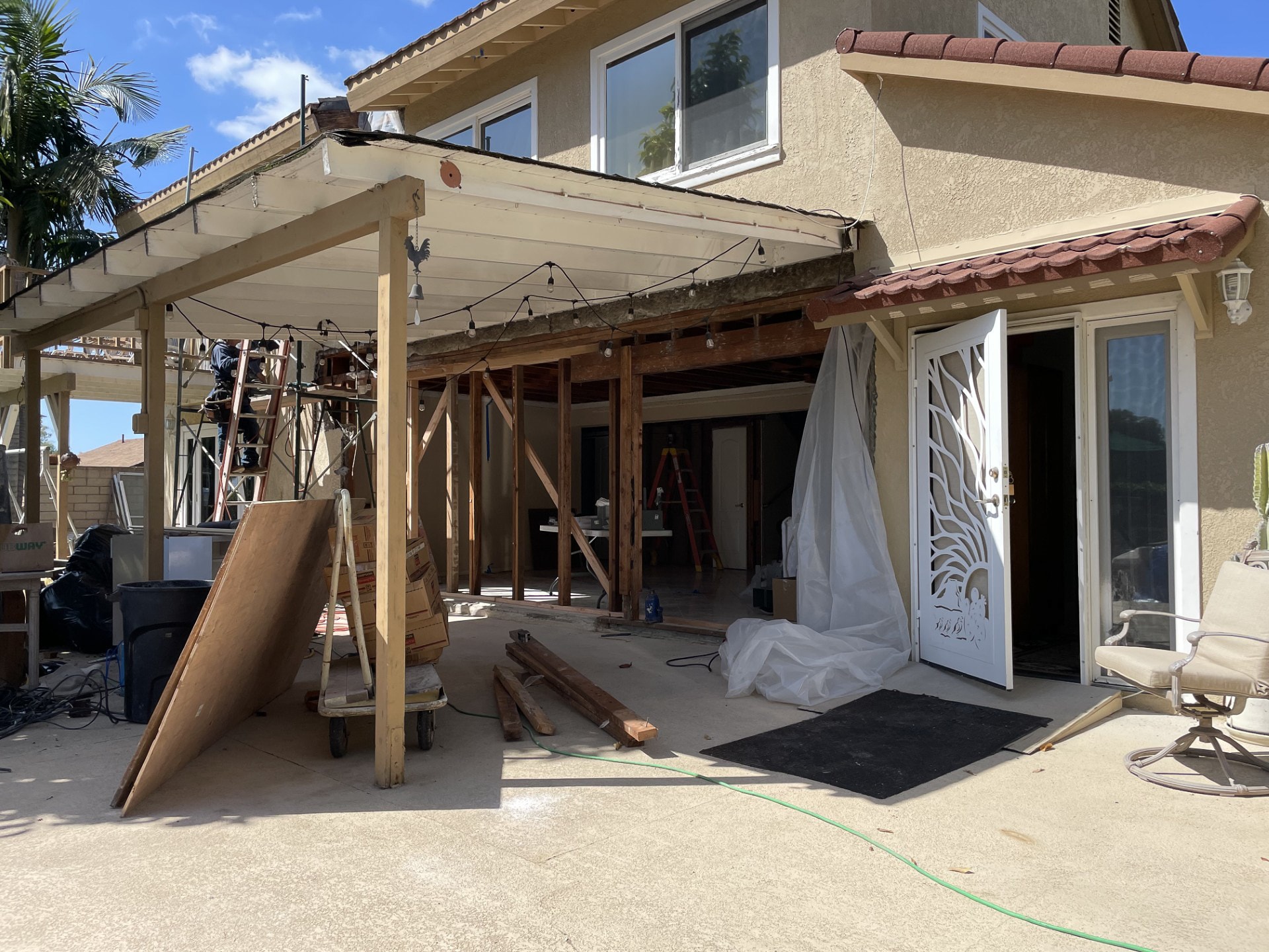 Older wooden pergola being removed to make room for a new aluminunm pergola from The Luxury Pergola.