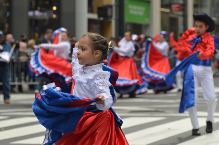 Children performing in a Hispanic Heritage Month parade. 