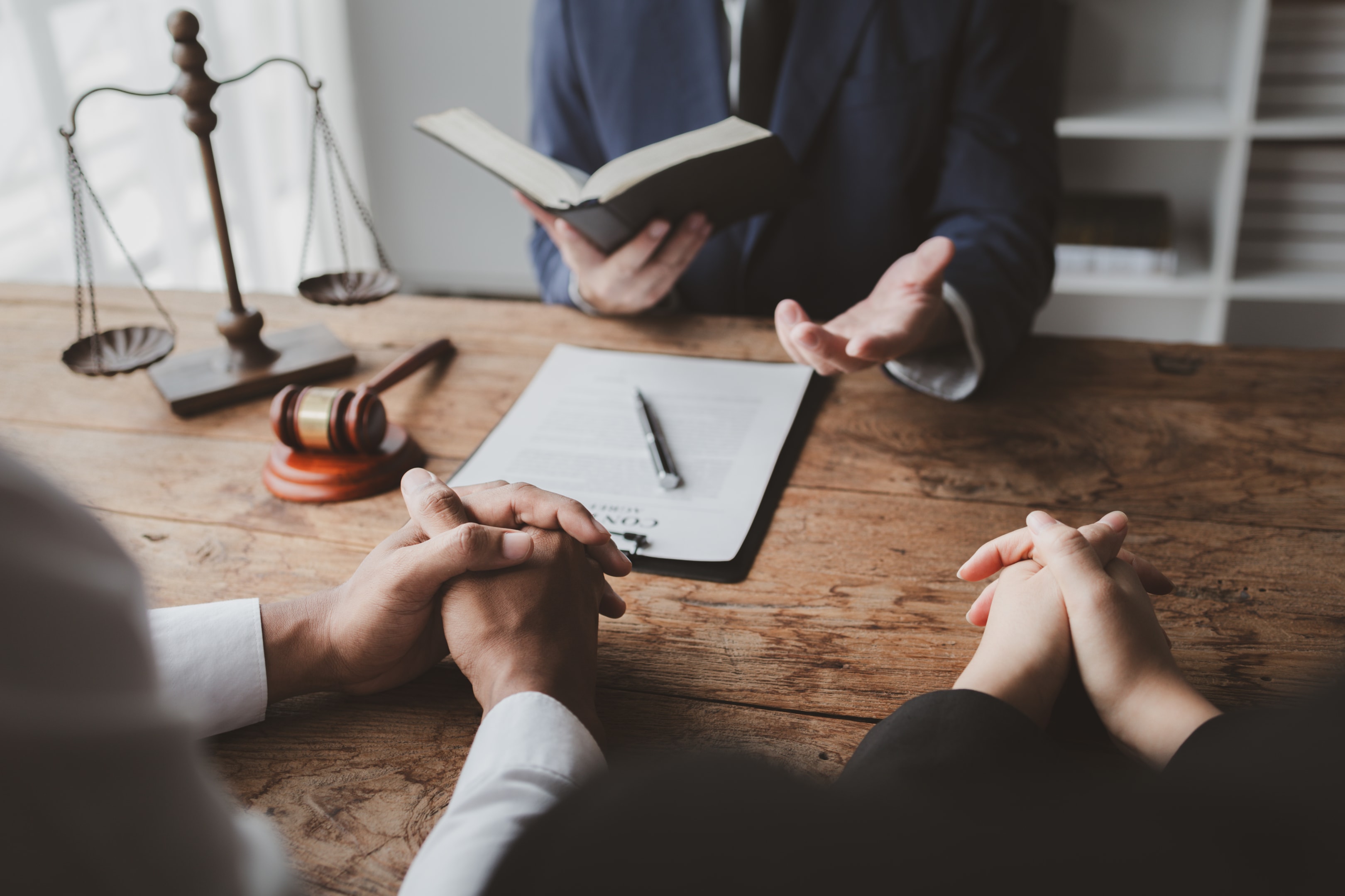 Clients meeting with a lawyer at a desk to discuss legal matters