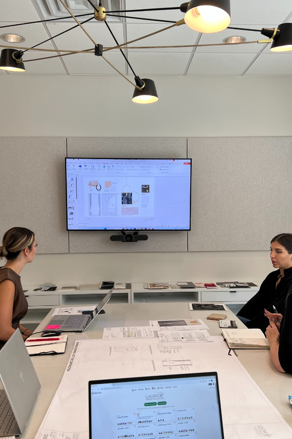 Two designers meeting in the studio to look at specs