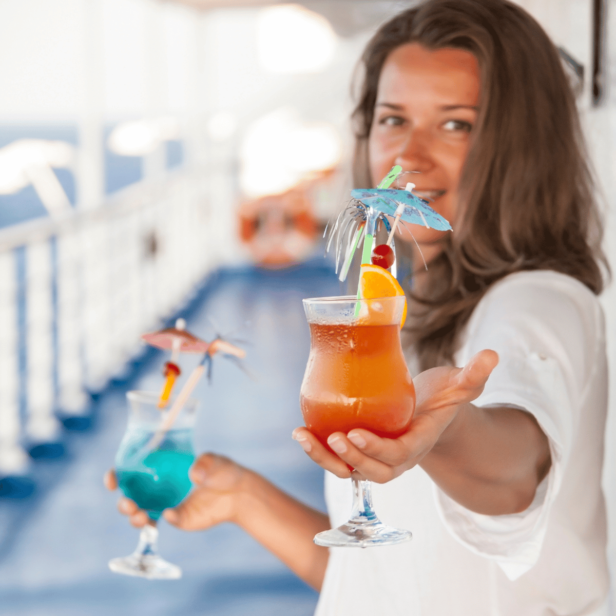 Woman offering a fancy cocktail on a cruise ship