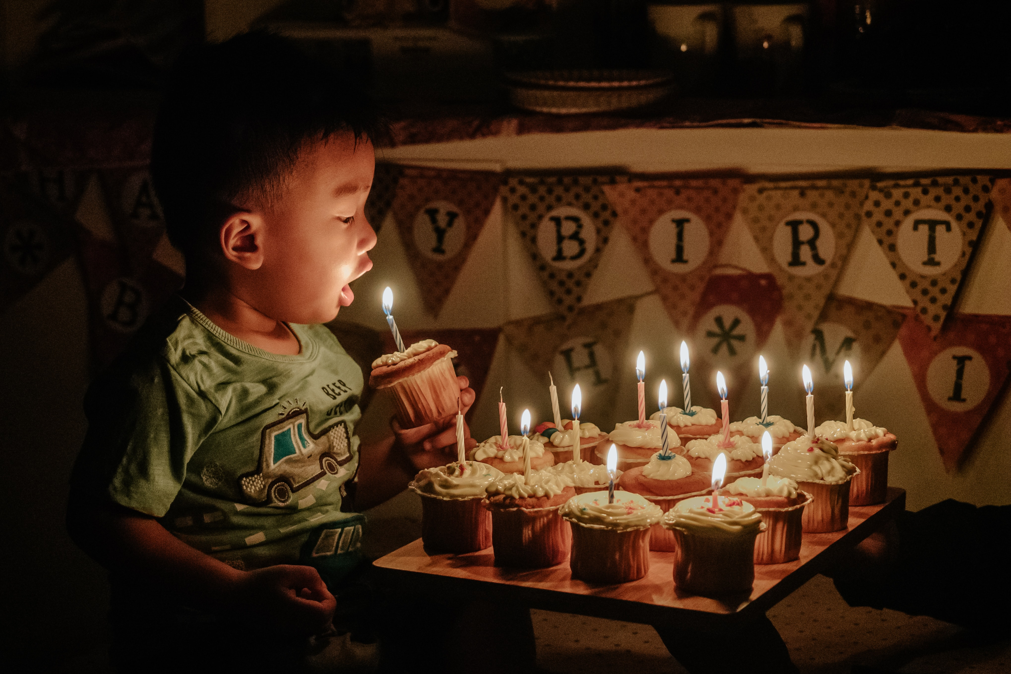 boy at home with birthday cake and banner
