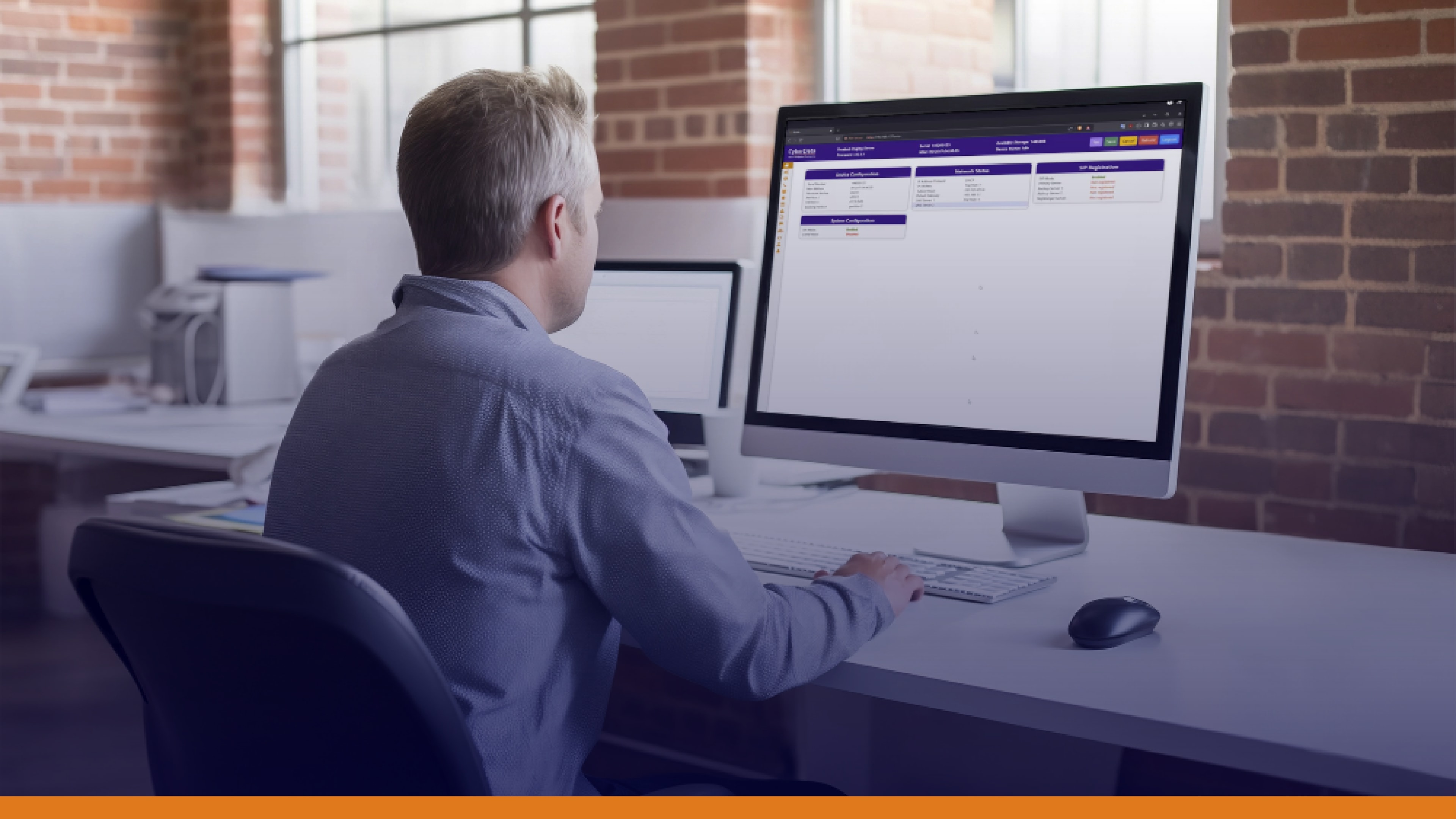 Man using a desktop computer in a modern office, highlighting the role of automated alerts and real-time notifications in responding to security threats through an efficient notification system.
