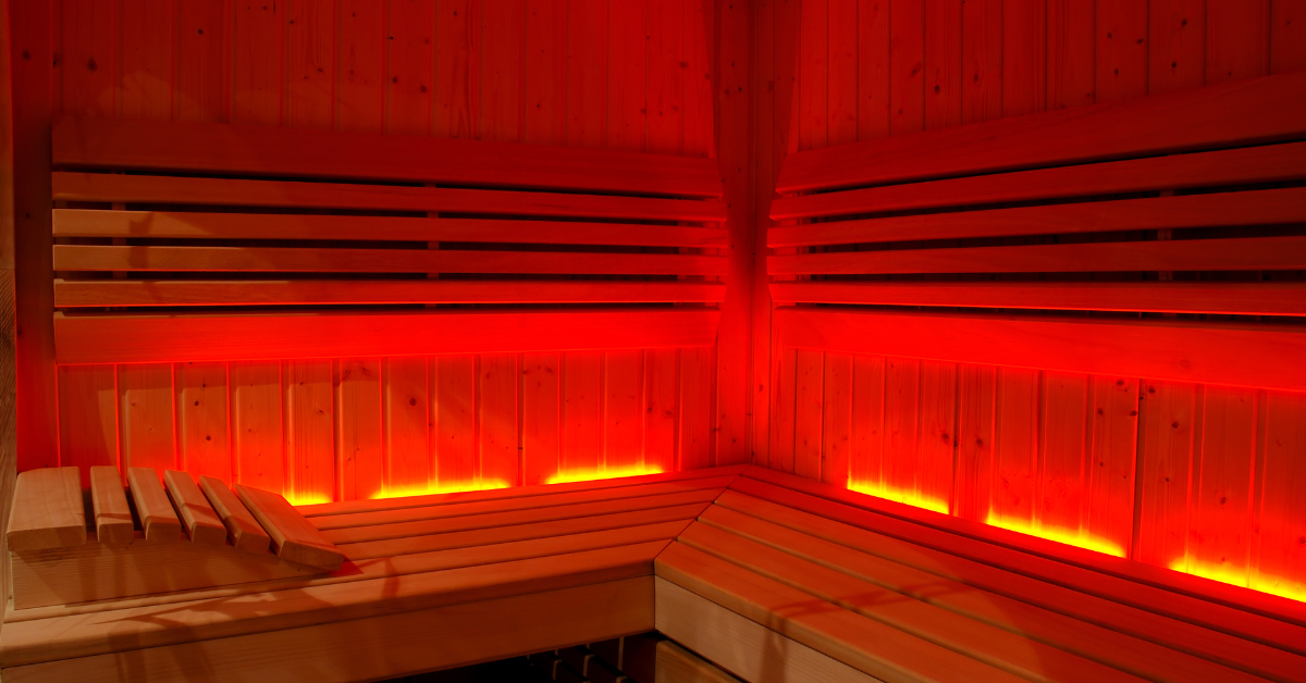 The inside of an infrared sauna, lit up red to symbolize infrared light.