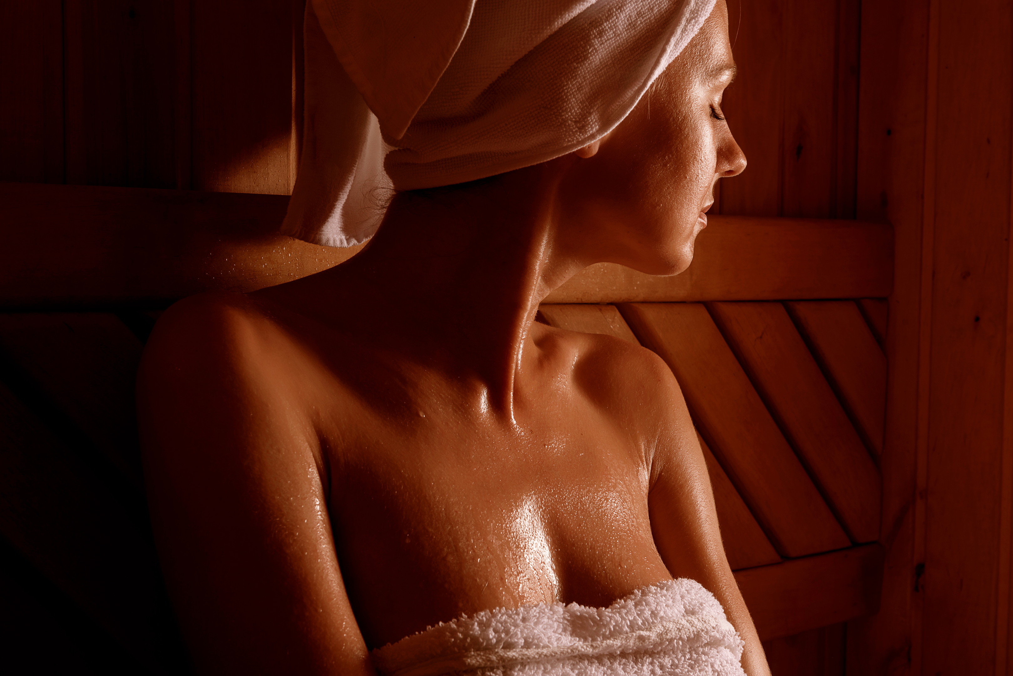 Image of a woman enjoying the inside of an Enlighten sauna.