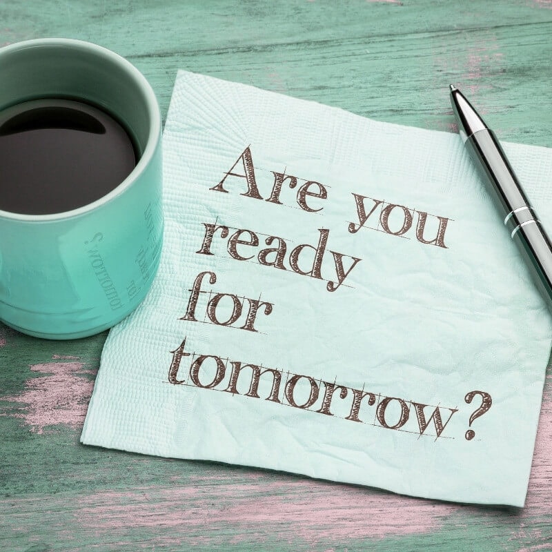 A green coffee mug and the words. "Are you ready for tomorrow?" written on it.