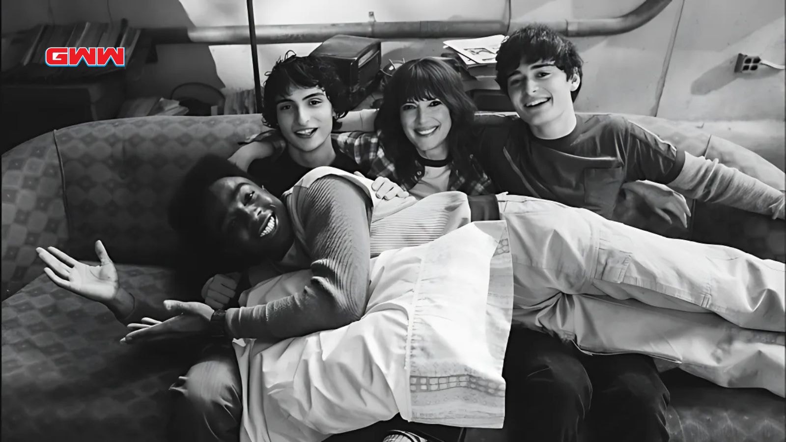 Finn Wolfhard as Mike Wheeler, Caleb McLaughlin as Lucas Sinclair, Winona Ryder as Joyce Byers, and Noah Schnapp as Will Byers behind the scenes of Stranger Things season 5