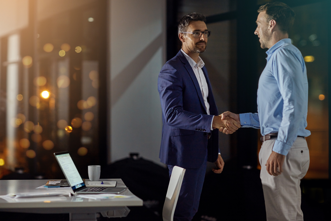 Two professionals sealing a high-stakes business deal with a handshake