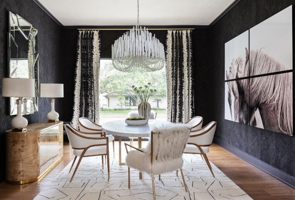 the black wall color in this black and white dining room is stunning when paired with accessories