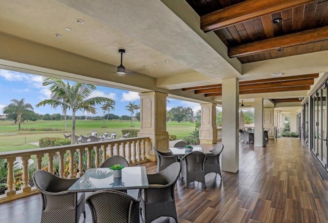 An aerial view of Vineyards Country Club showcases lush golf courses interspersed with luxury homes, highlighting the community's contemporary urban fabric set against the backdrop of Southwest Florida's natural beauty. The image captures the harmonious blend of recreational areas and residential properties, emphasizing the allure of this upscale real estate destination.