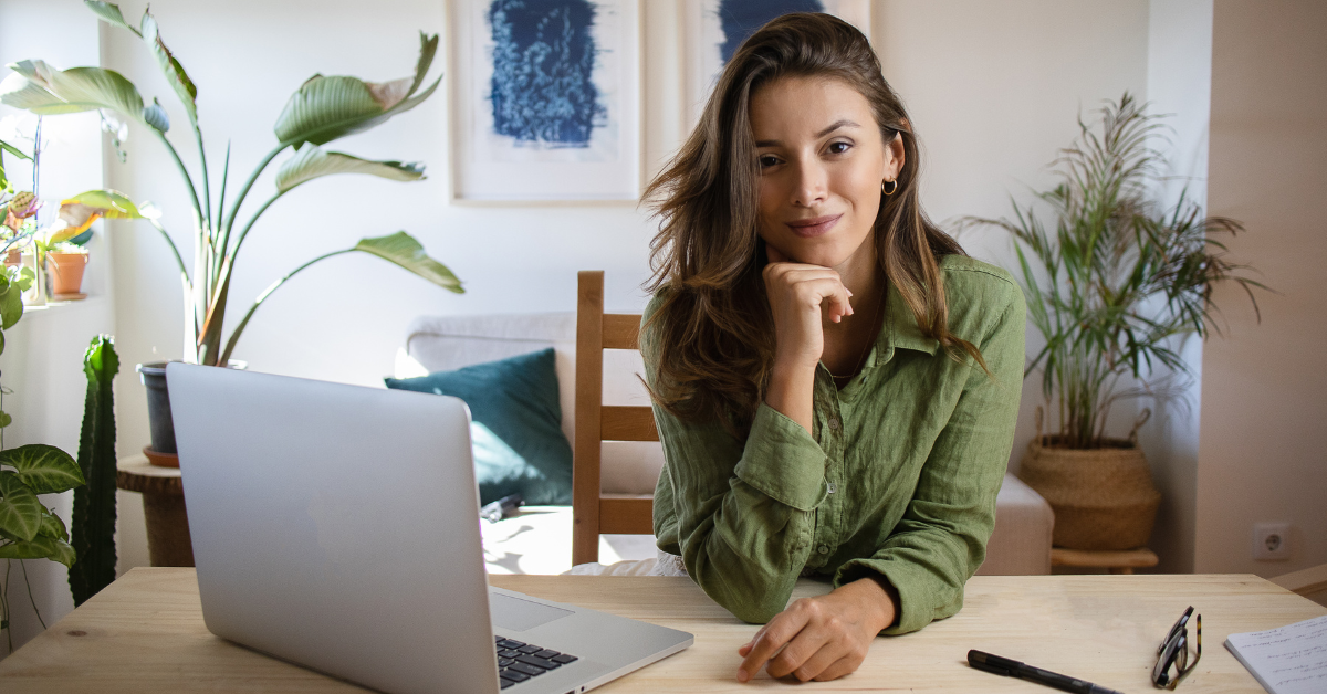 A woman on her laptop knowing What is the tax limit for onlyfans?