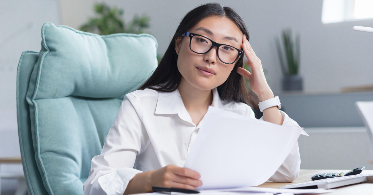 Woman reviewing financial documents and understanding what is a tax voucher for her OnlyFans income.