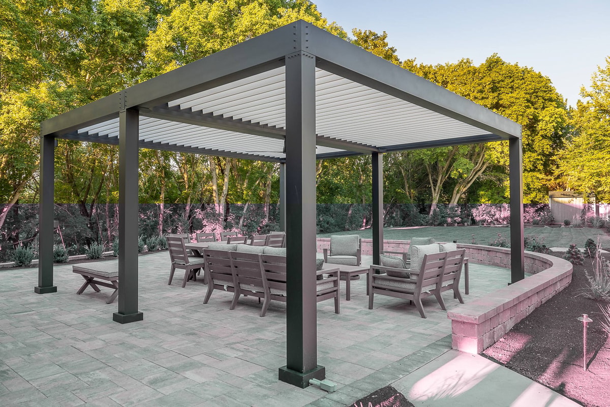 Freestanding super pergola installed over patio with outdoor seating in an outdoor living space.