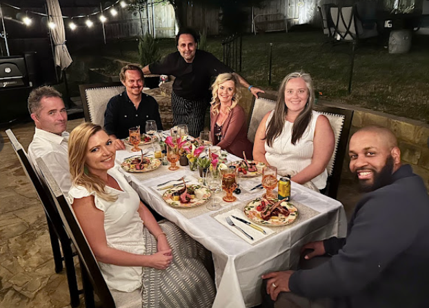 Group of people enjoying a meal with a private chef in Austin