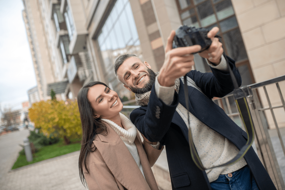 Couple in scenic New York location, conquering adult ADHD symptoms and capturing selfie moments for social media, showcasing progress and connection.