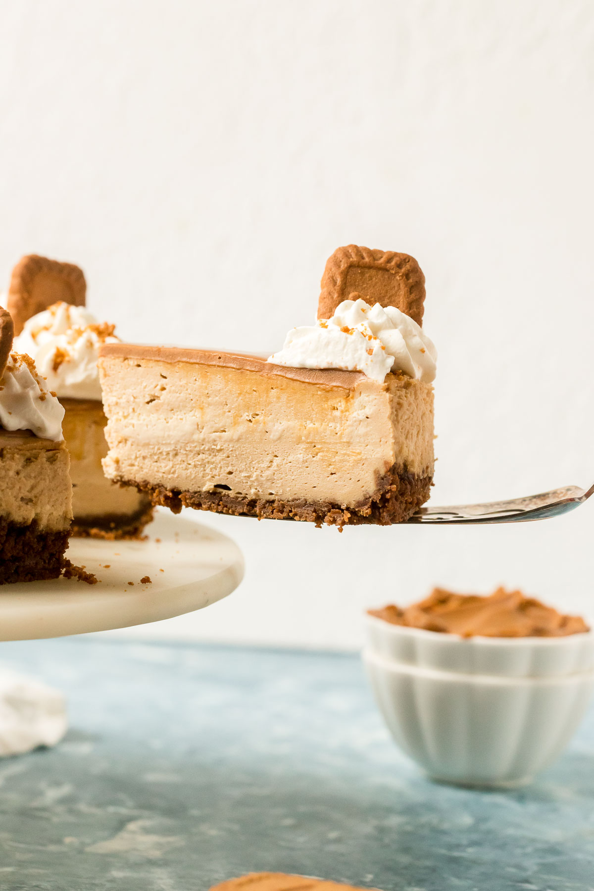 slice of biscoff cheesecake on a cake server