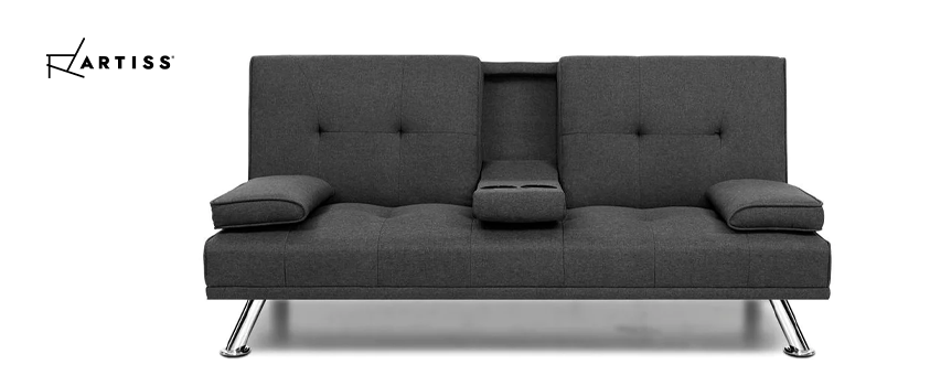 An Artiss grey fabric two seater sofa bed with the centre cup holder lowered. 