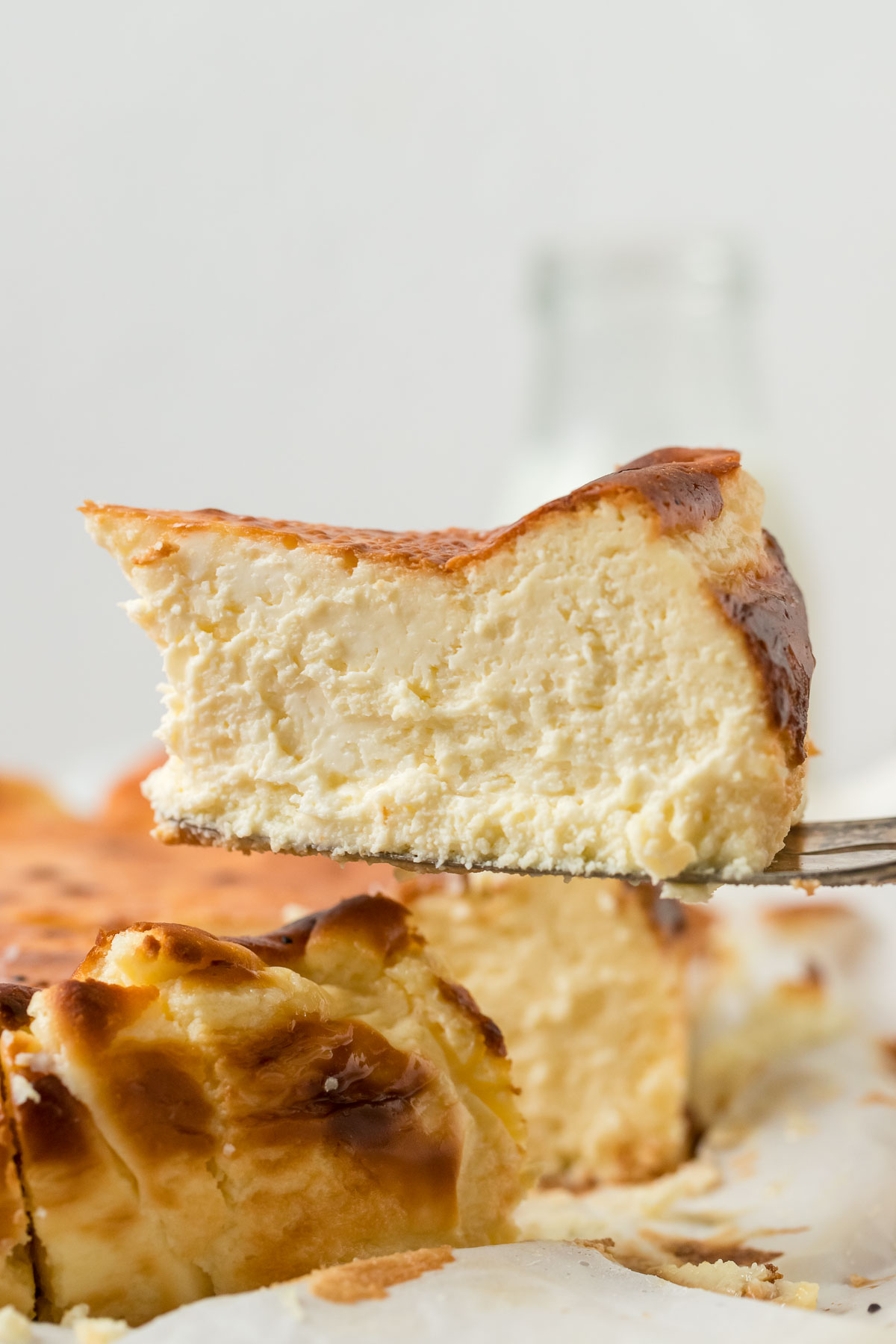 slice of basque cheesecake on a cake server