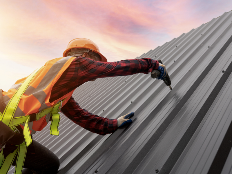 An image of a skilled contractor installing a new metal roof in San Antonio, TX.