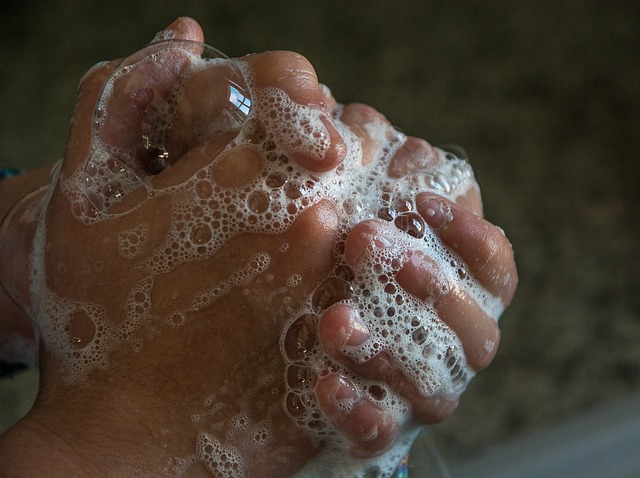 An image of a person washing their hands with soapy water.
