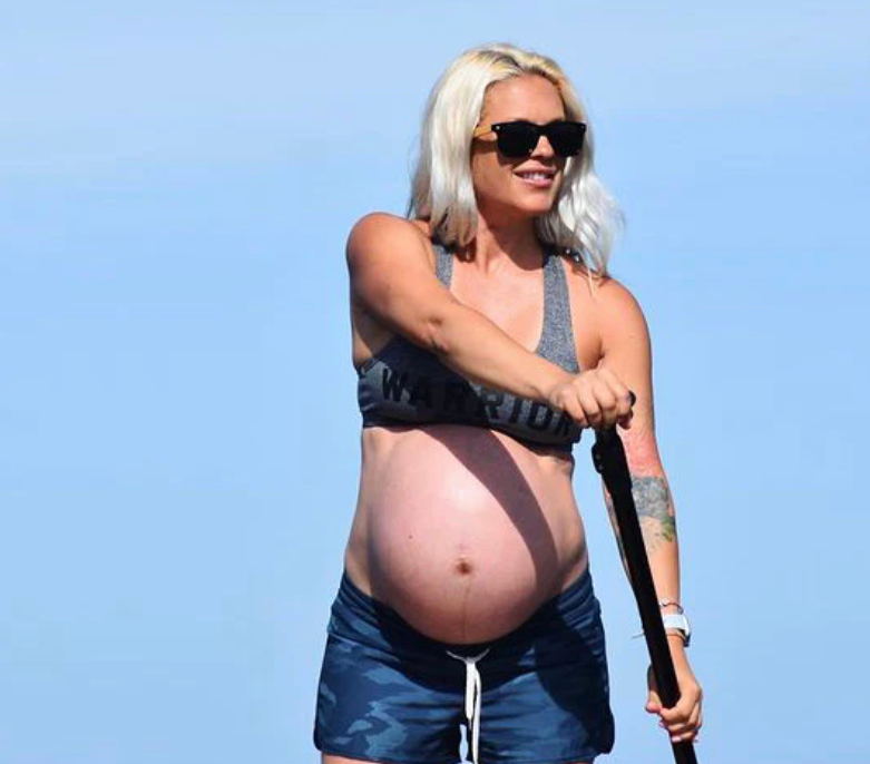 pregnant woman on a paddle board