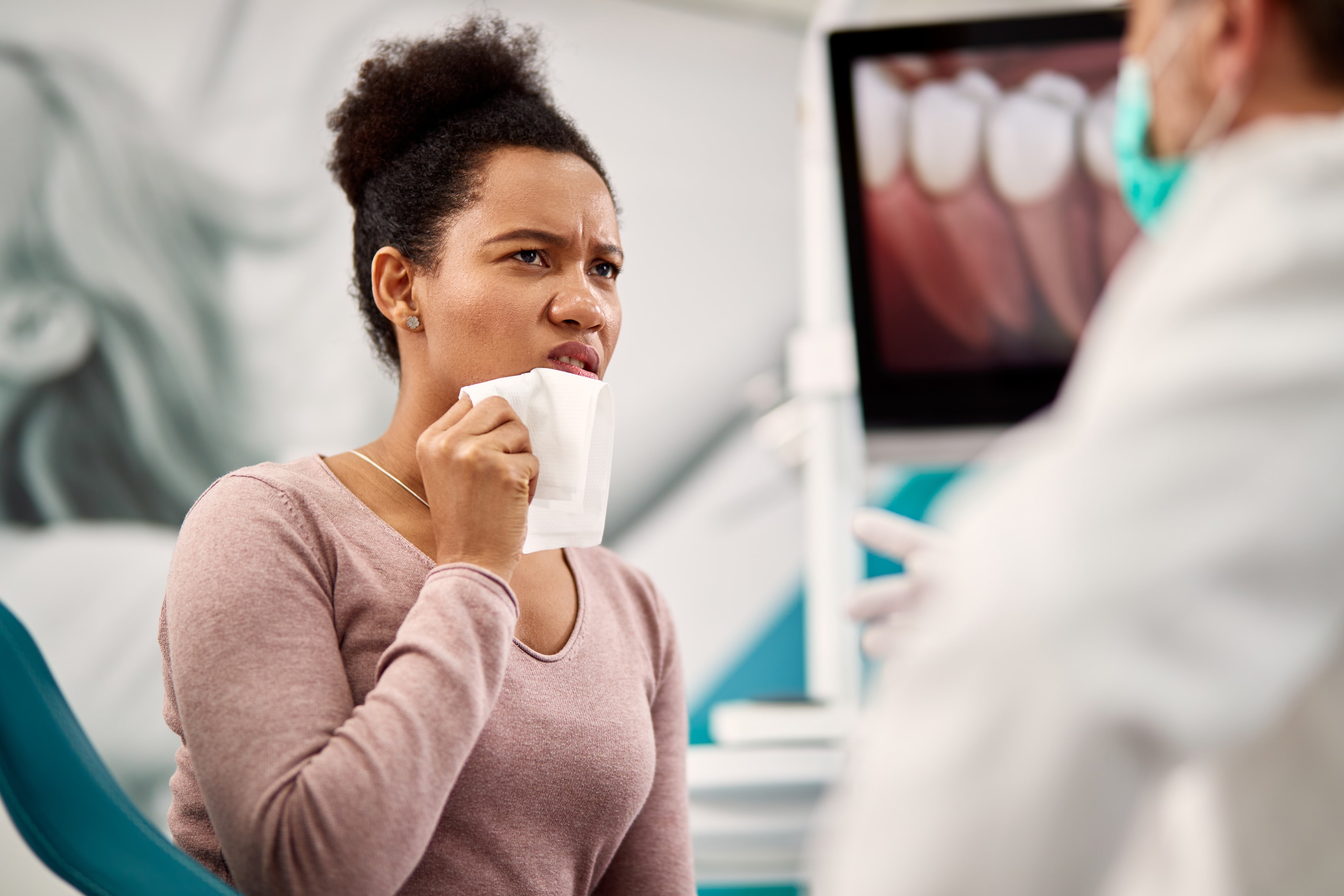 Woman with infected gums at an oral surgery office