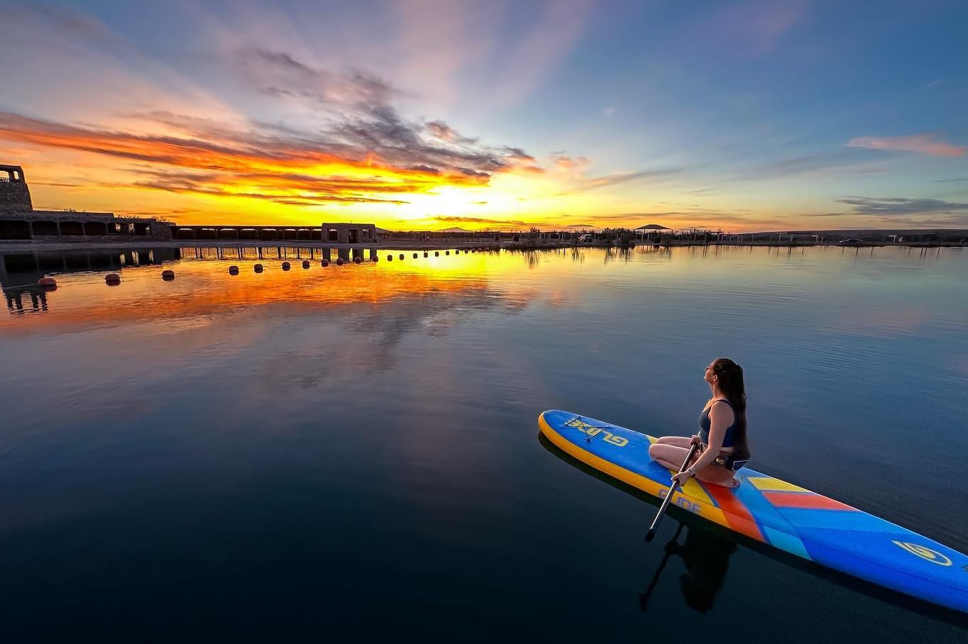 kneeling on an inflatable paddle board