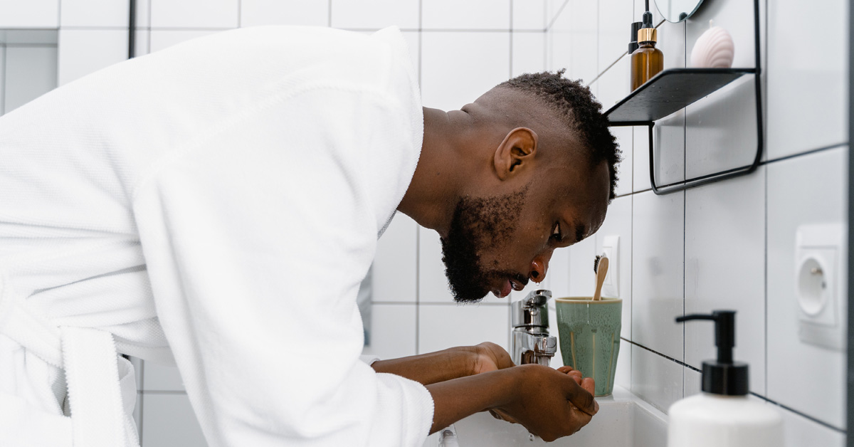 black man washing face