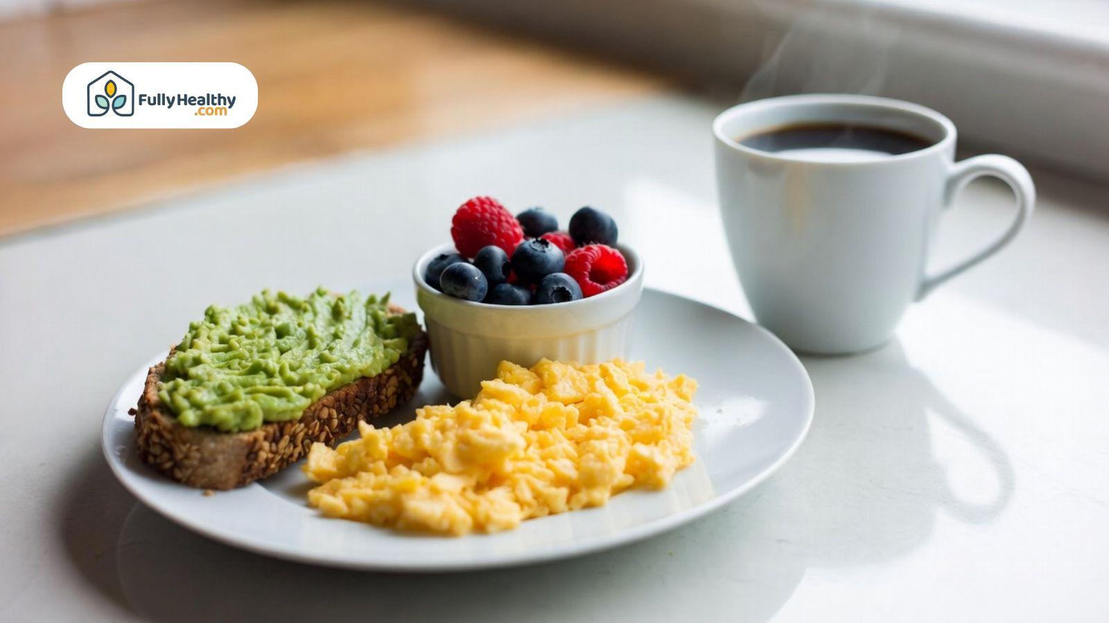 Diabetic-friendly breakfast plate with avocado toast, scrambled eggs, berries, and black coffee.