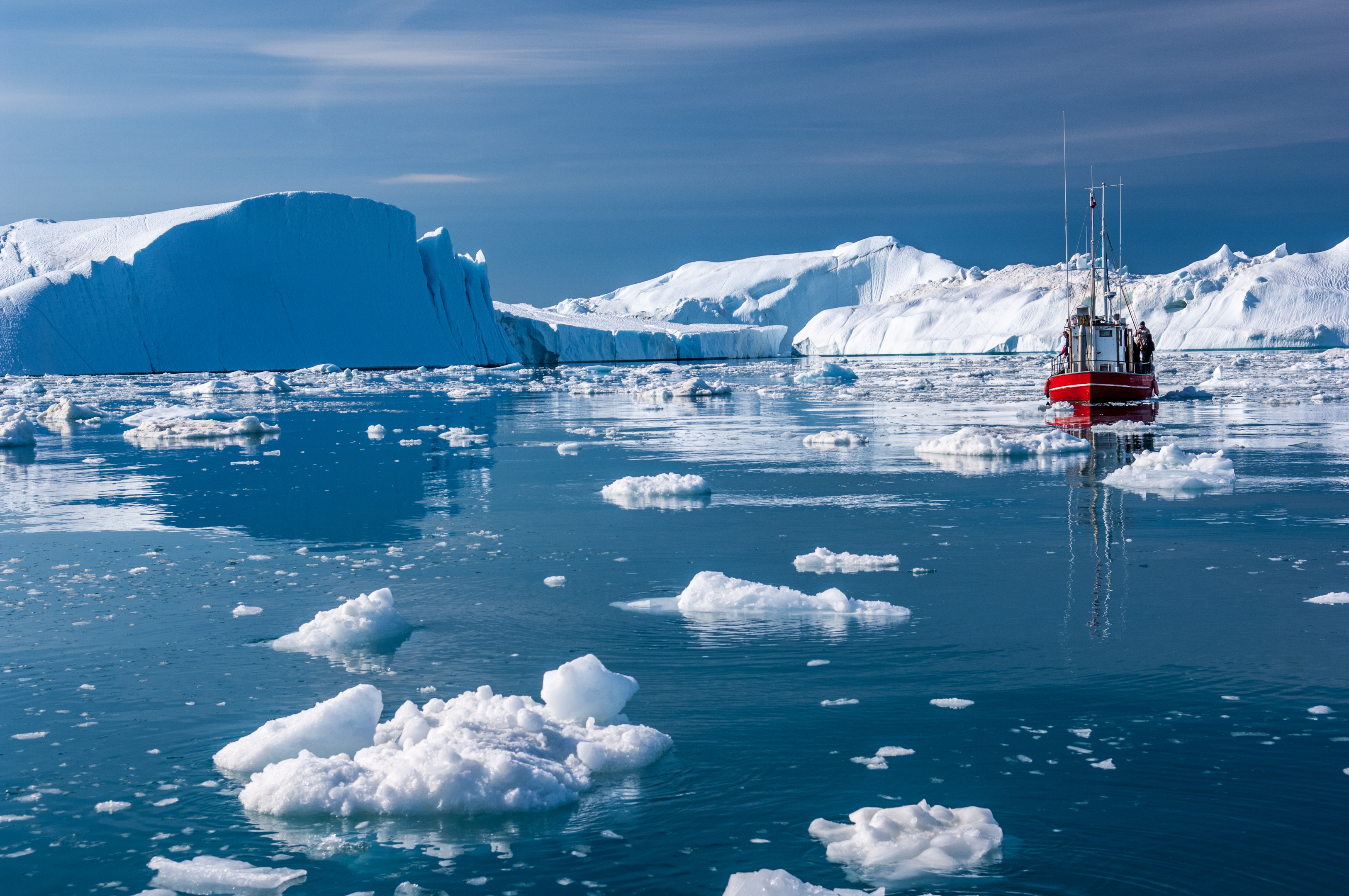 Fishing boat amongst ice bergs in Greenland