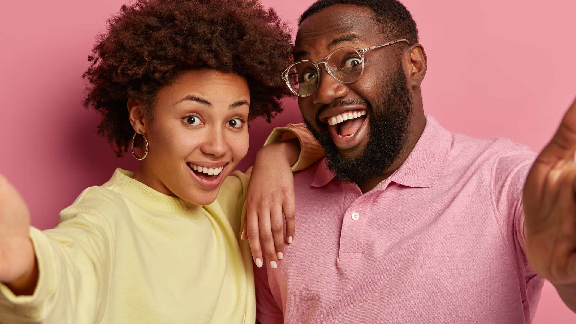 Top 10 Probiotics in South Africa - The Good Stuff featuring a cheerful couple taking a selfie with a bright pink background.